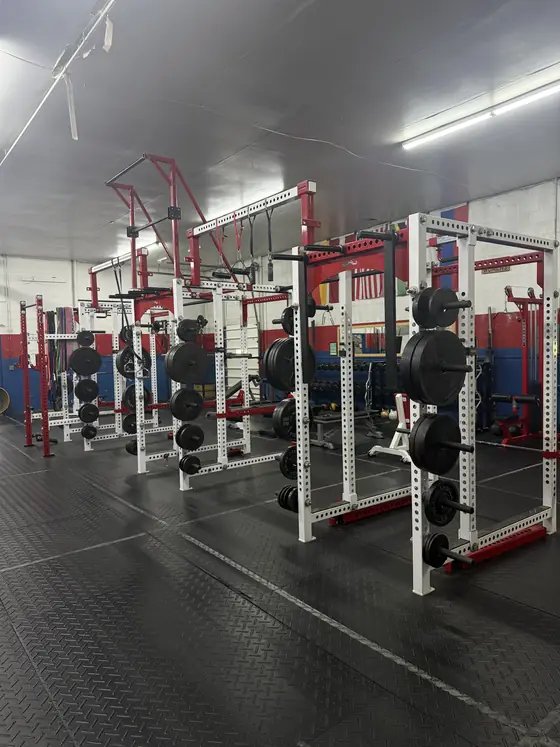 Squat racks lined up on the strength floor at Legacy Gym